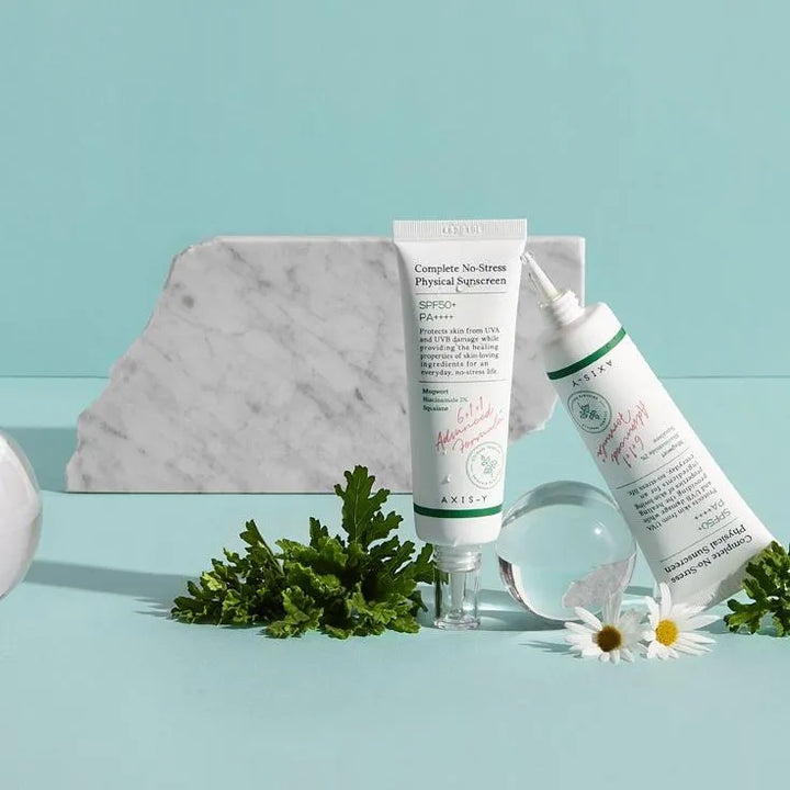 AXIS-Y Complete No-Stress Physical Sunscreen with SPF 50, plants and daisies on a blue background, Korean skincare Nederland at Me Time Groningen.