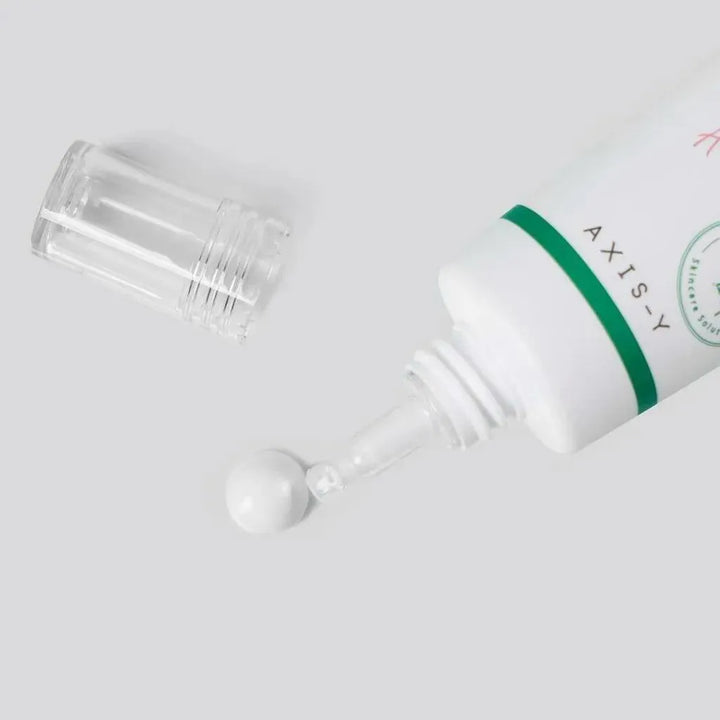 AXIS-Y sunscreen tube with cap open and cream on light background, Korean skincare product