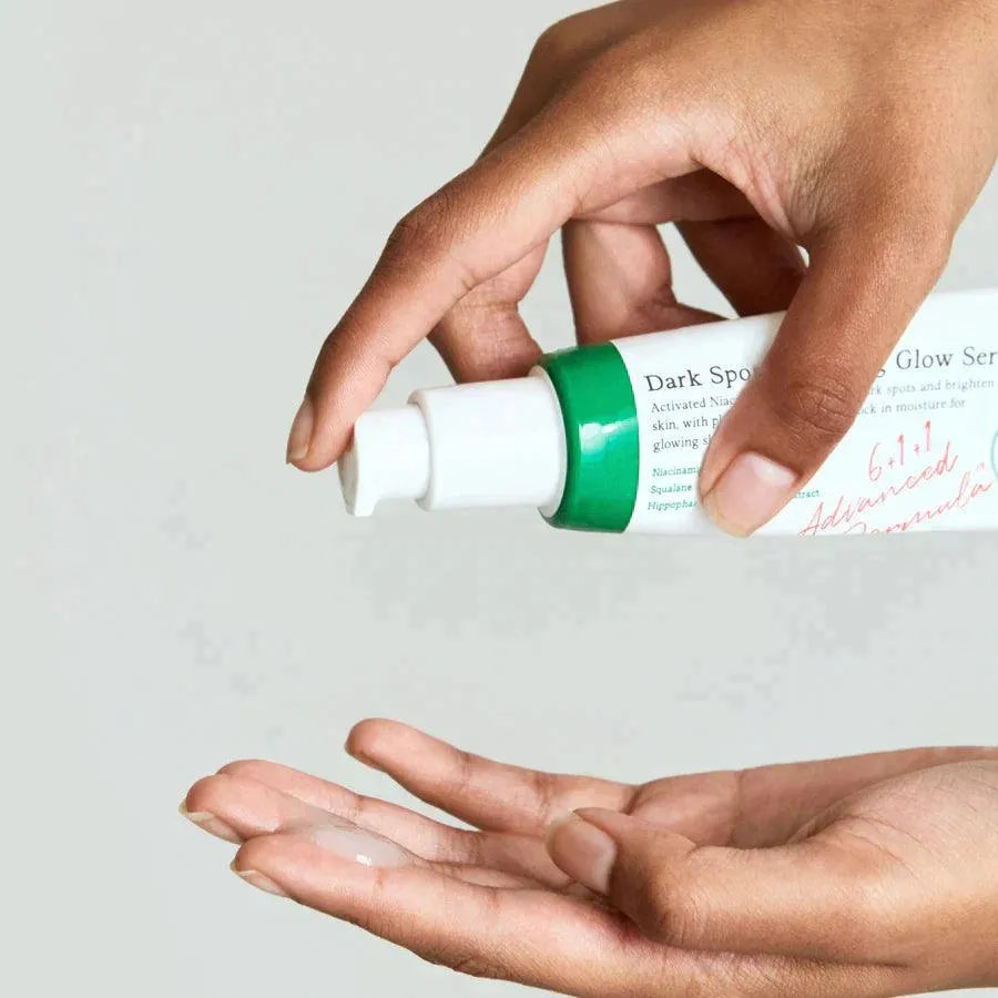 Hand applying AXIS-Y Dark Spot Correcting Glow Serum, Korean skincare product