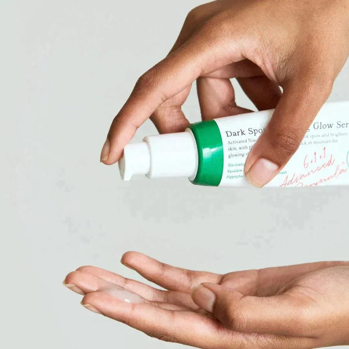 Hand applying AXIS-Y Dark Spot Correcting Glow Serum, Korean skincare product