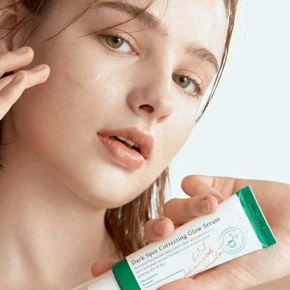 Woman applying Axis-Y Dark Spot Correcting Glow Serum, Korean skincare at Me Time Groningen.