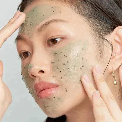Woman applying Axis-Y mugwort pore clarifying wash off pack, Korean skincare Groningen