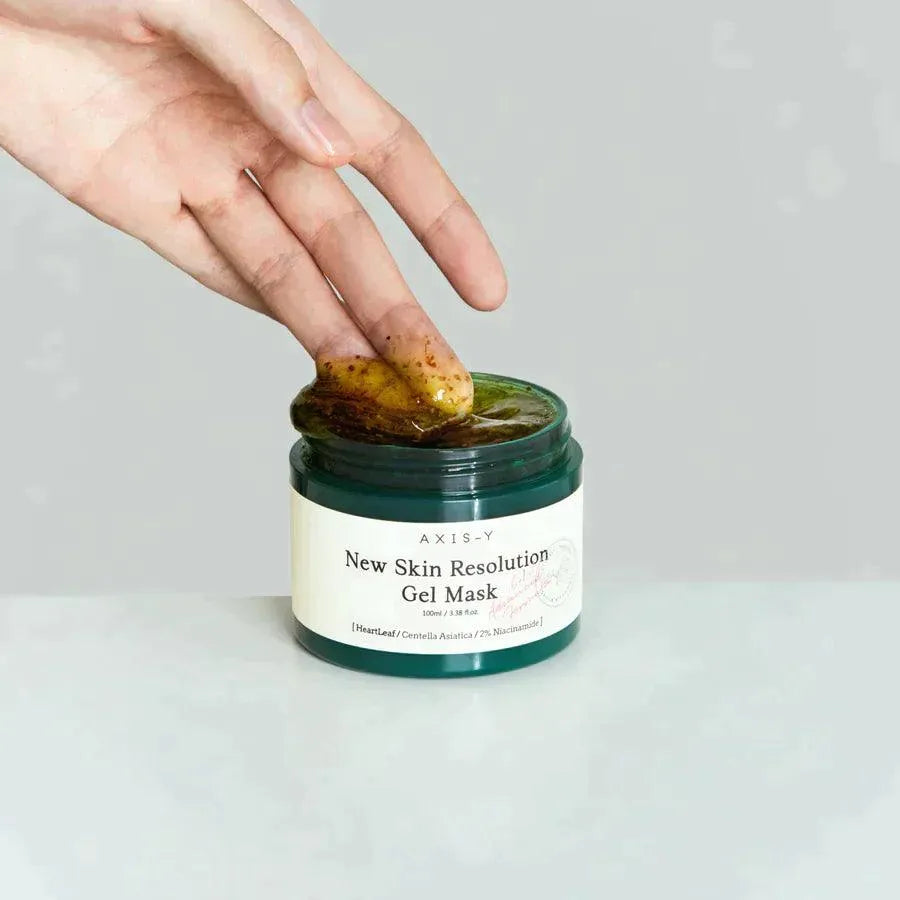 Hand scooping AXIS-Y New Skin Resolution Gel Mask, Korean skincare product, on white background