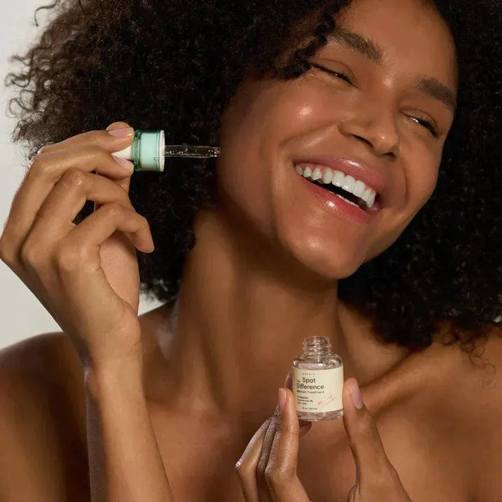 Smiling woman applying Axis-Y Spot The Difference Blemish Treatment, Korean skincare Nederland