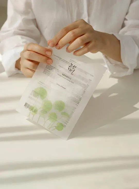Person holding Beauty of Joseon Centella Asiatica calming mask, Korean skincare product
