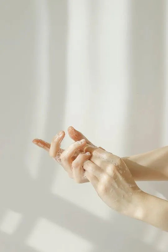 Hands lathering with foaming Korean cleanser, soft natural light, Me Time Groningen skincare