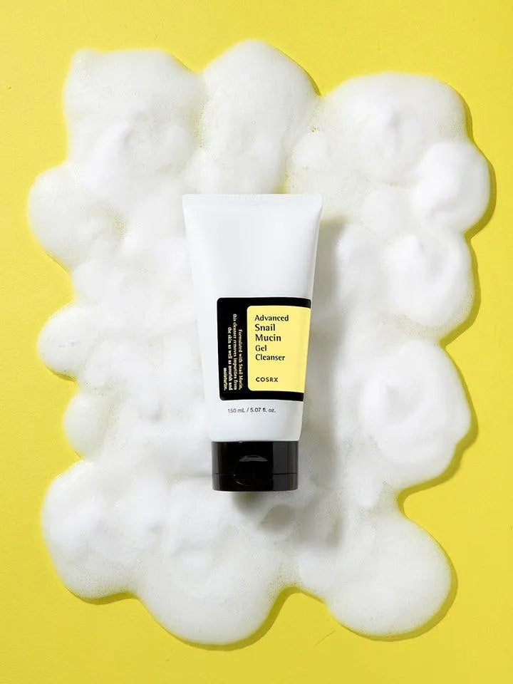 COSRX Advanced Snail Mucin Gel Cleanser on foamy bubbles, yellow background, Korean skincare Netherlands