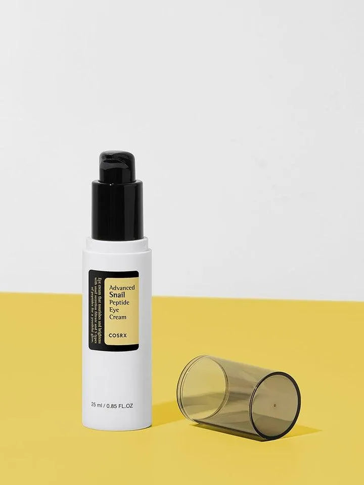 COSRX Advanced Snail Peptide Eye Cream bottle on yellow surface, Korean skincare Me Time Groningen