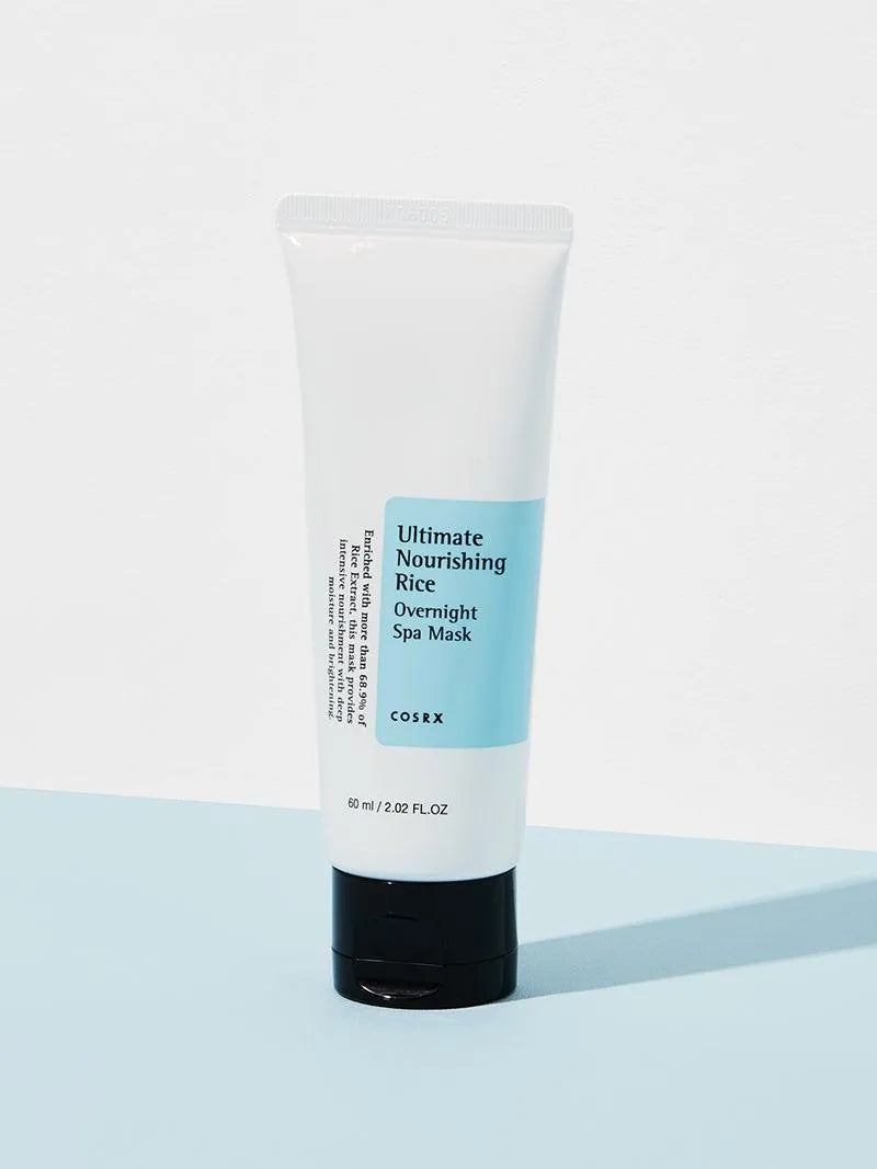 COSRX Ultimate Nourishing Rice Overnight Spa Mask tube on a light blue surface, Korean skincare