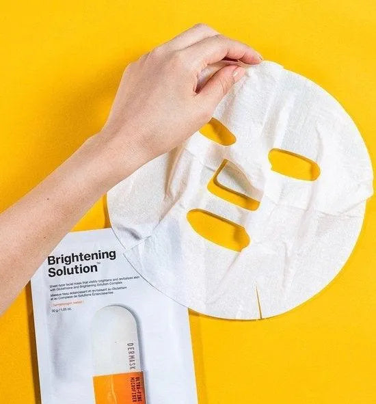 Hand holding Dr. Jart+ Brightening Solution Korean sheet mask on yellow background