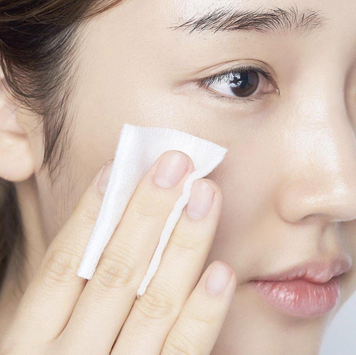 Applying toner with cotton pad on clear skin, Korean skincare routine, Me Time Groningen