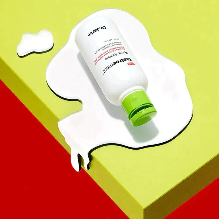 Dr.Jart+ Teatreement Toner bottle on yellow surface with white liquid splash, Korean skincare