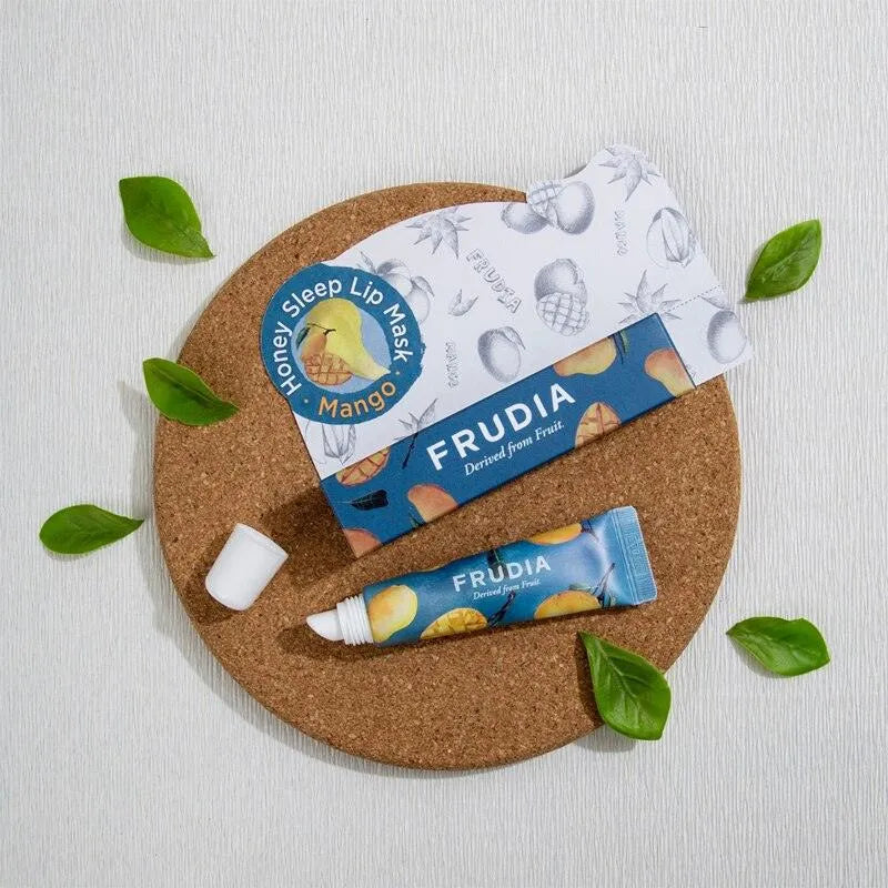 Frudia Mango Honey Sleep Lip Mask tube and box, with green leaves, from Me Time Groningen Korean skincare shop.