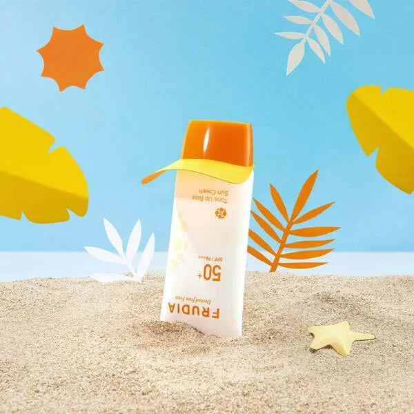 Frudia Tone Up Base Sun Cream SPF 50 on sand, colorful summer beach background, Korean skincare