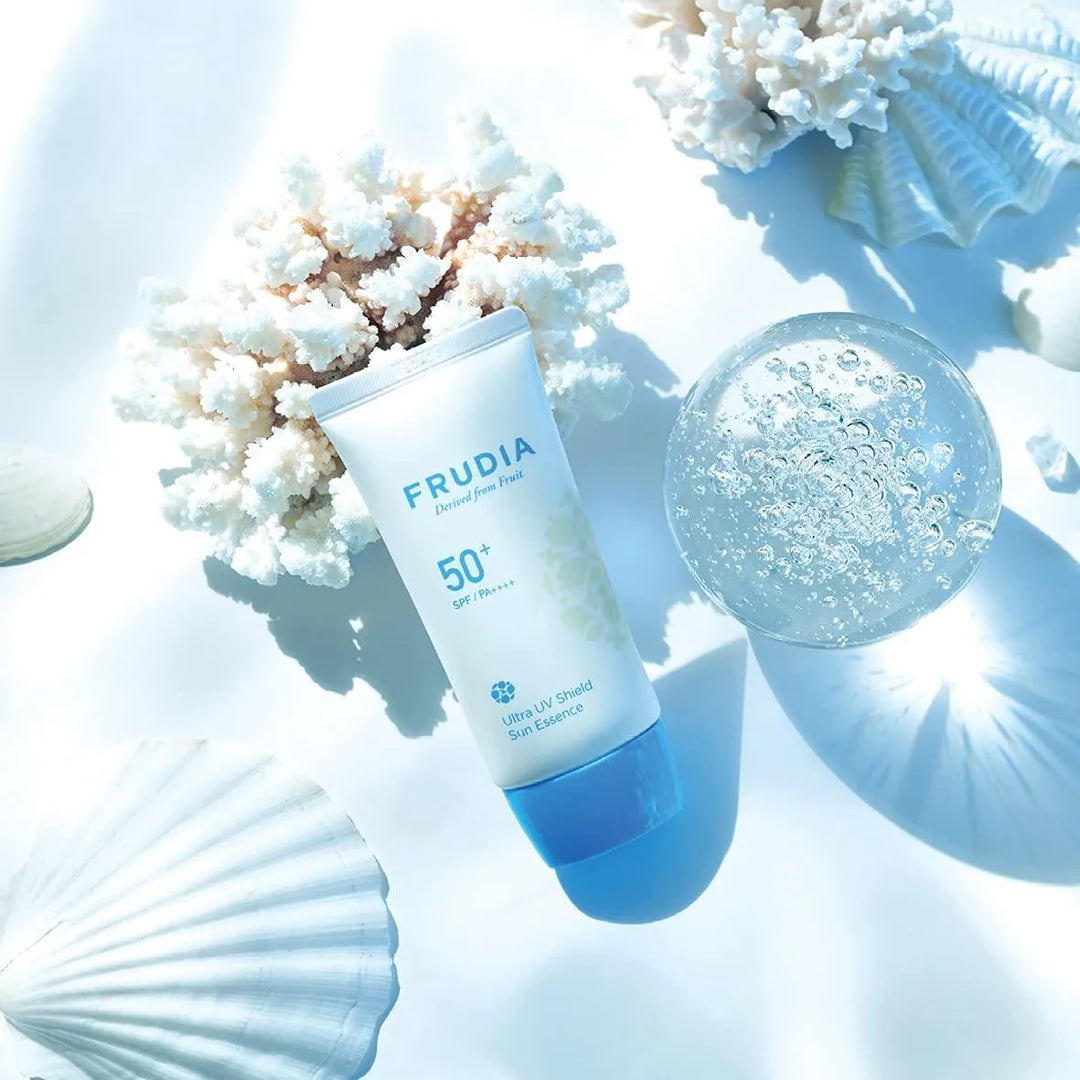 Frudia Ultra UV Shield Sun Essence SPF 50+ sunscreen with seashells and coral, Korean skincare Nederland.