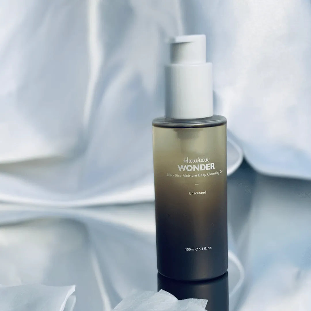 Haruharu Wonder Black Rice Moisture Deep Cleansing Oil bottle on reflective surface, Korean skincare