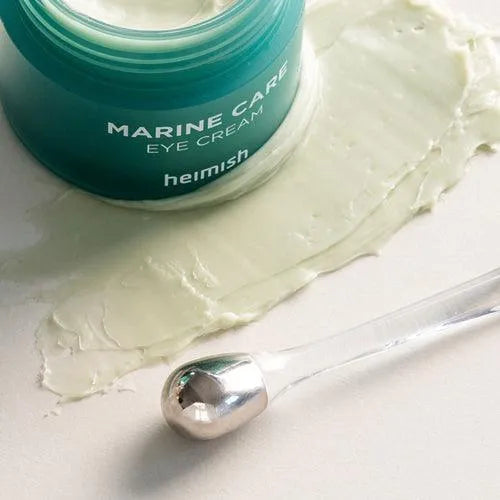 Heimish Marine Care Eye Cream open jar with cream and silver applicator, Korean skincare product