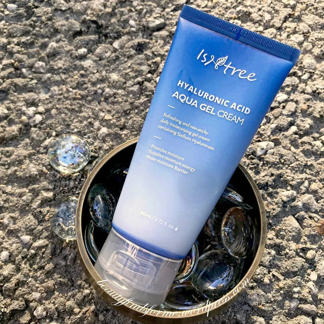Isntree Hyaluronic Acid Aqua Gel Cream tube on pebbled ground in glass bowl, Korean skincare product
