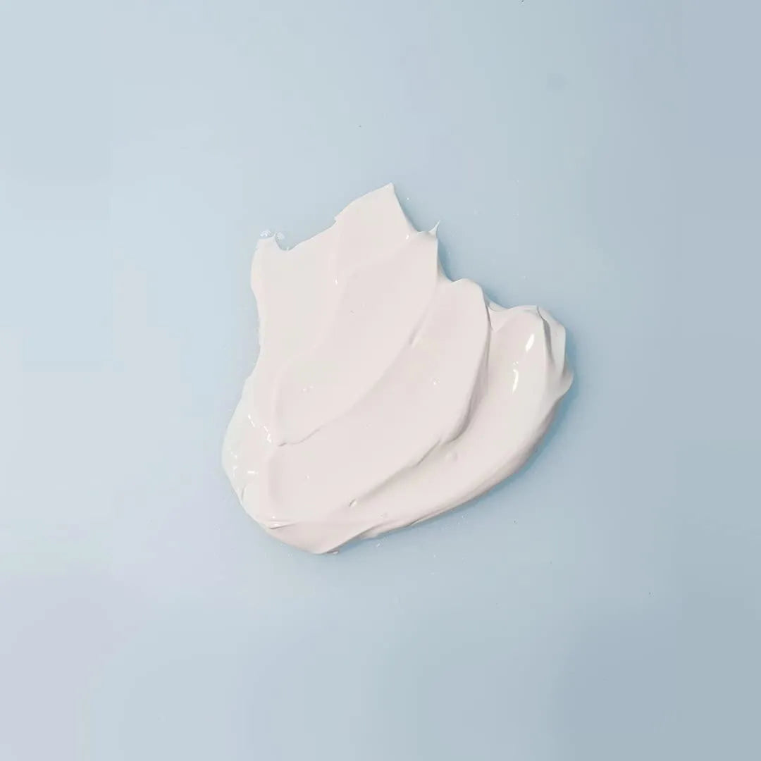 Texture of Isntree Hyaluronic Acid Natural Sun Cream on light blue background, Korean skincare