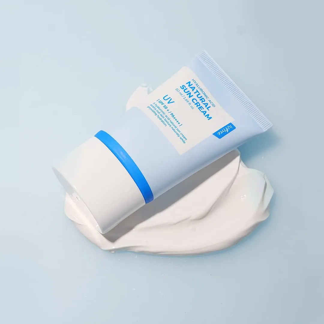 Isntree Hyaluronic Acid Natural Sun Cream tube with cream on light blue background, Korean skincare product at Me Time Groningen