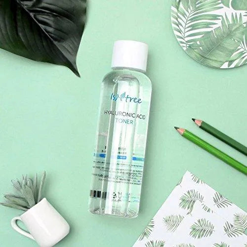 Isntree Hyaluronic Acid Toner on mint green background with leaves, Korean skincare product