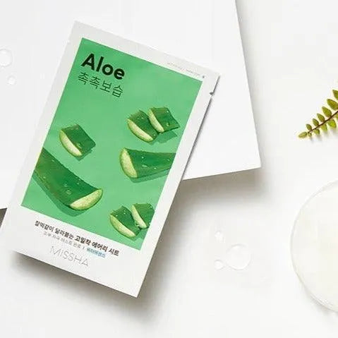 Missha Airy Fit Aloe sheet mask Korean skincare product flat lay, with aloe slices, at Me Time Groningen.