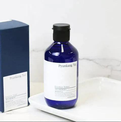 Pyunkang Yul Essence Toner bottle and box on white tray, Korean skincare at Me Time Groningen