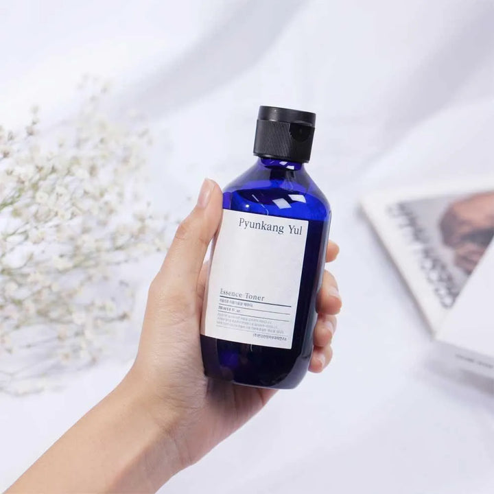 Hand holding Pyunkang Yul Essence Toner bottle, Korean skincare at Me Time Groningen