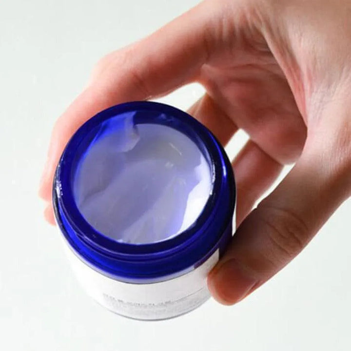 Hand holding open blue jar of Pyunkang Yul Moisture Cream, Korean skincare at Me Time Groningen