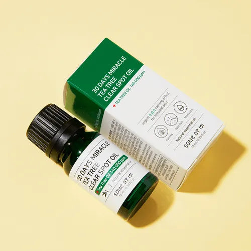 Some By Mi 30 Days Miracle Tea Tree Clear Spot Oil bottle and box, Korean skincare product on yellow background