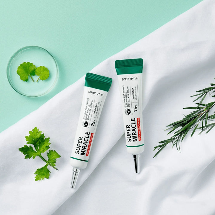 Some By Mi AHA BHA PHA 14 Days Super Miracle Spot All Kill Cream tubes on mint background with herbs, Korean skincare at Me Time Groningen.