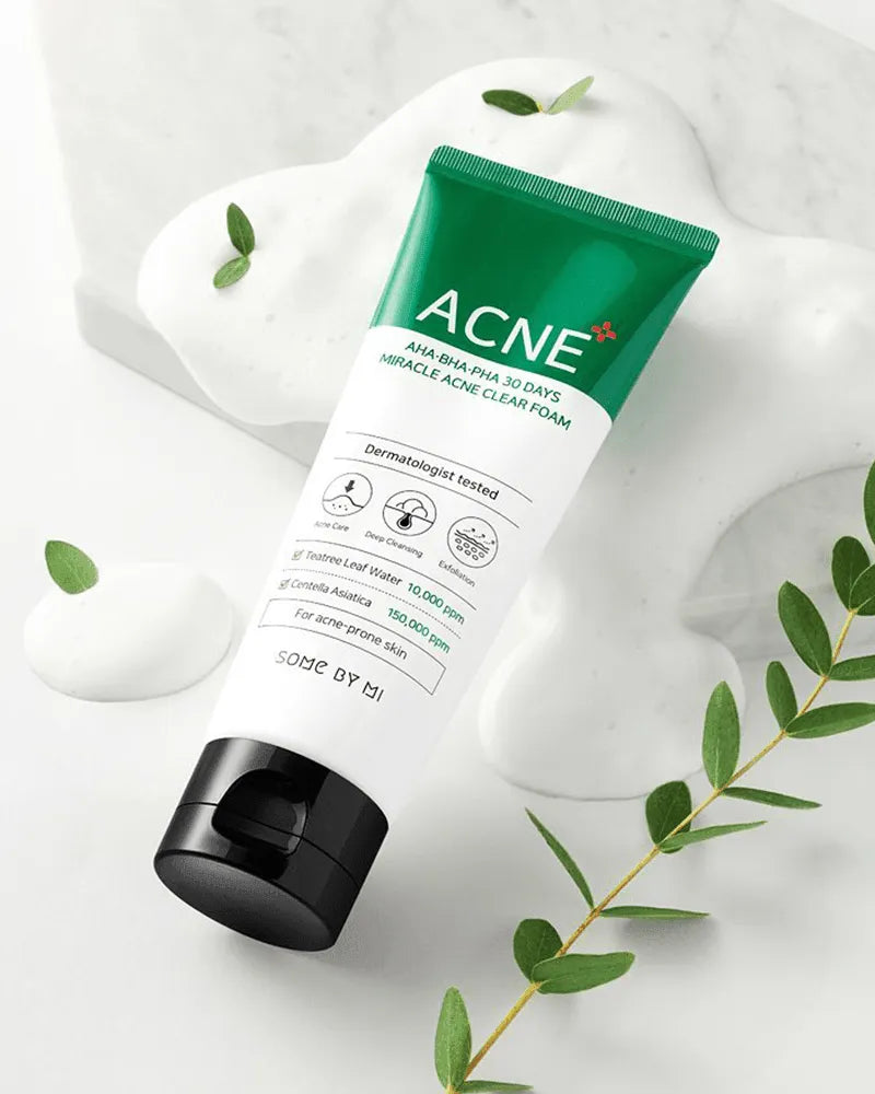 SOME BY MI AHA BHA PHA 30 Days Miracle Acne Clear Foam tube on white foam with green leaves, Korean skincare at Me Time Groningen.