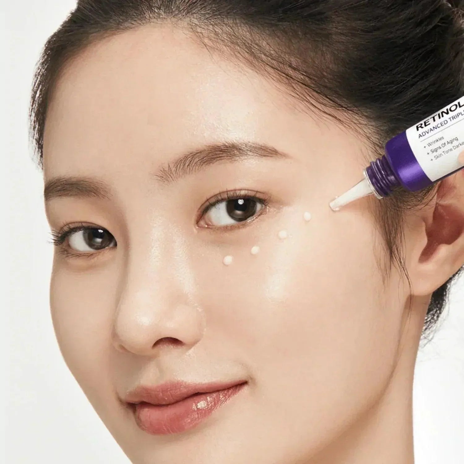 Woman applying Some By Mi Retinol Intense Advanced Triple Action Eye Cream, Korean skincare