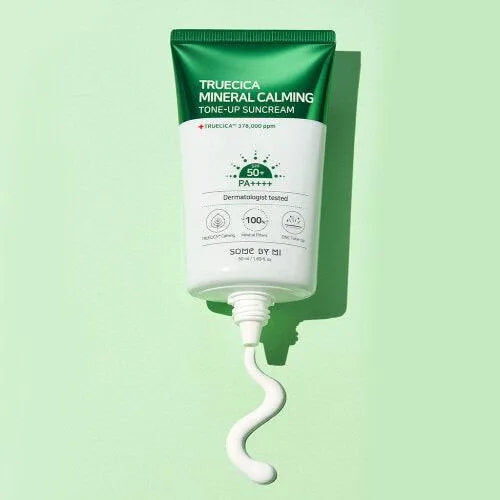 Some By Mi Truecica Mineral Calming Tone-Up Suncream tube on a green background, Korean skincare Me Time Groningen