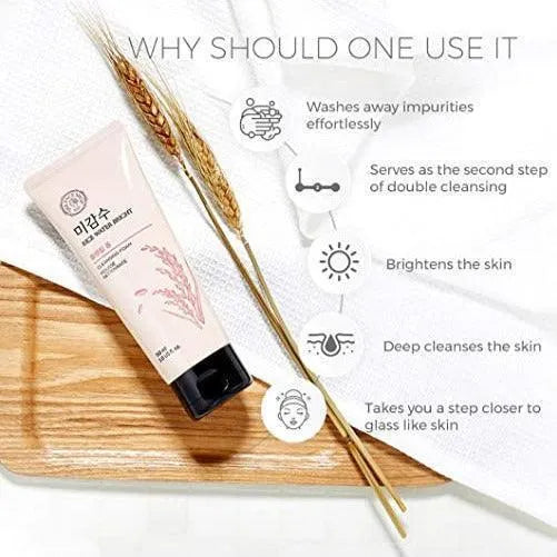 The Face Shop Rice Water Bright Cleansing Foam Korean skincare on wooden tray with rice stalks, benefits listed.